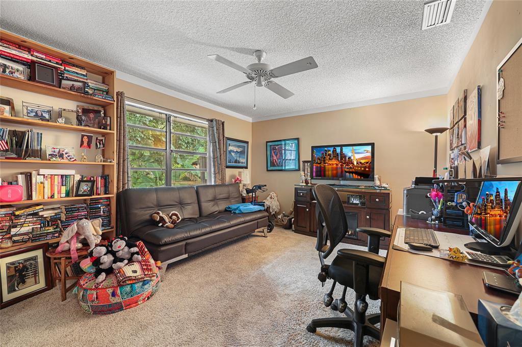 9700 Northwest 28th Street Hollywood, FL 33024 - Photo 55 of 76 a living room with fireplace furniture and a flat screen tv