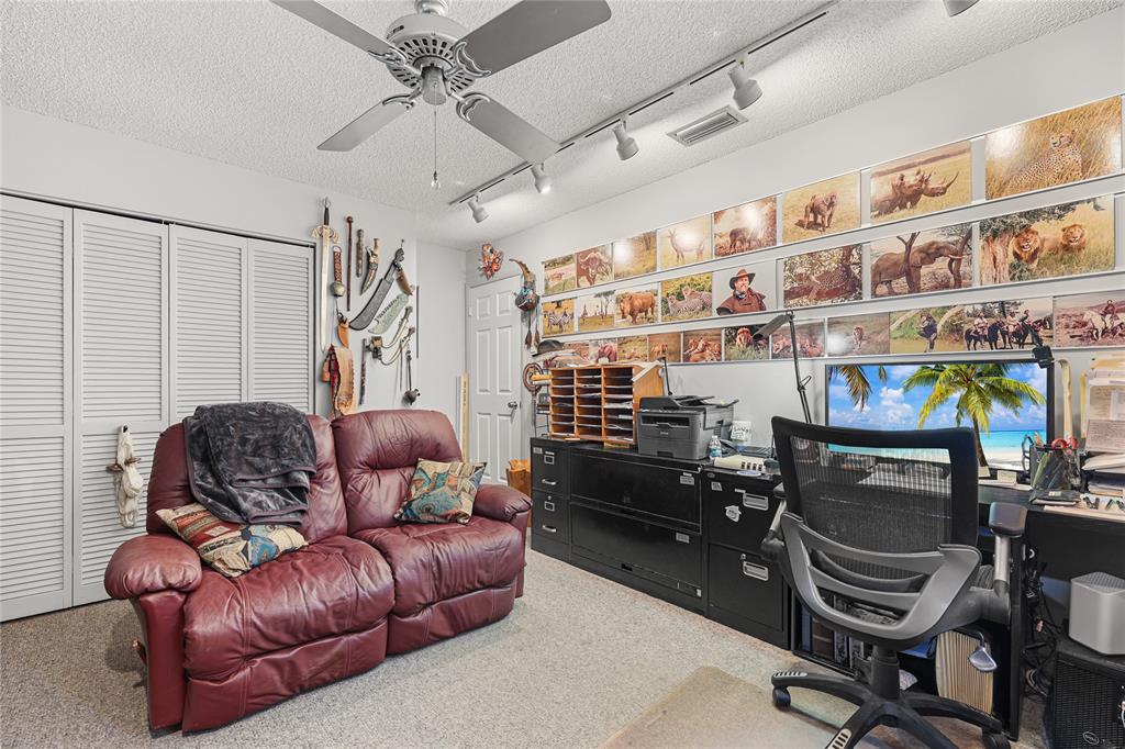 9700 Northwest 28th Street Hollywood, FL 33024 - Photo 58 of 76 a living room with furniture and a flat screen tv