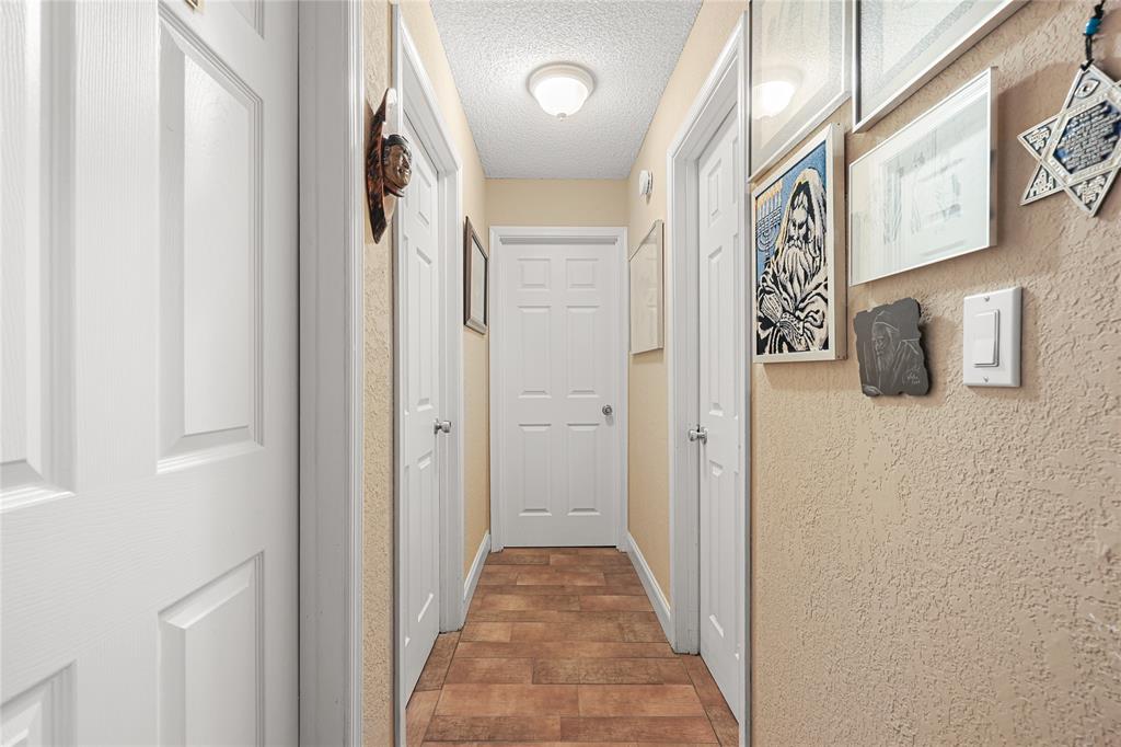 9700 Northwest 28th Street Hollywood, FL 33024 - Photo 59 of 76 a view of a hallway with wooden cabinets