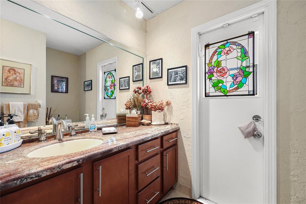 9700 Northwest 28th Street Hollywood, FL 33024 - Photo 62 of 76 a bathroom with a granite countertop sink mirror and a