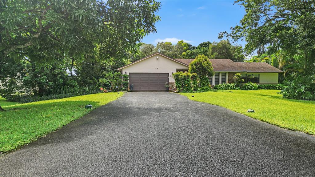 9700 Northwest 28th Street Hollywood, FL 33024 - Photo 72 of 76 a view of a house with a big yard and large trees