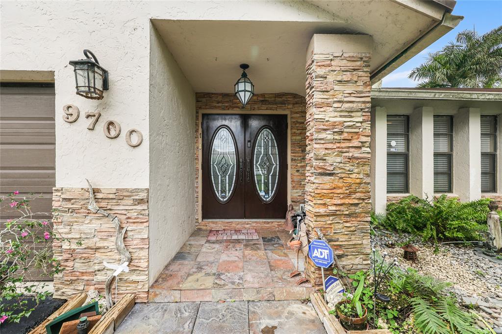 9700 Northwest 28th Street Hollywood, FL 33024 - Photo 9 of 76 a front view of a house with a garden