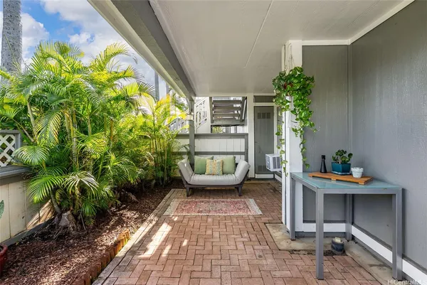 a front view of a house with outdoor seating