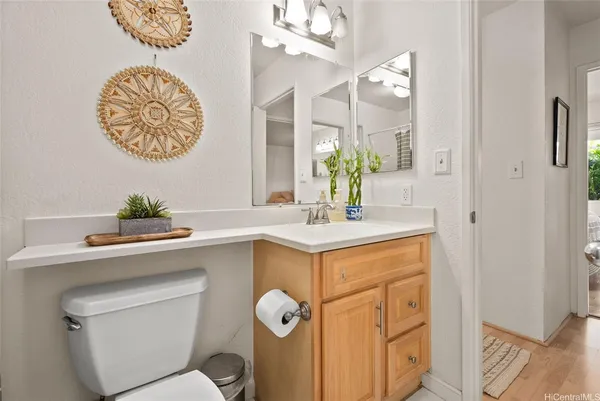 a bathroom with a sink a mirror and a toilet