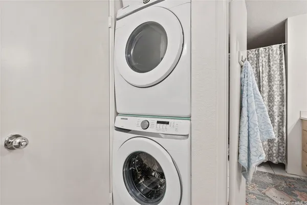 a view of a hallway with washer and dryer
