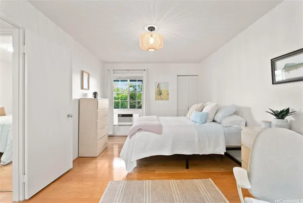 a bedroom with a bed and window