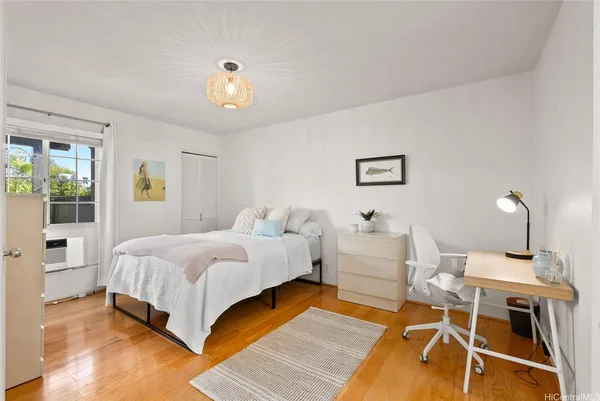 a bedroom with a bed and wooden floor
