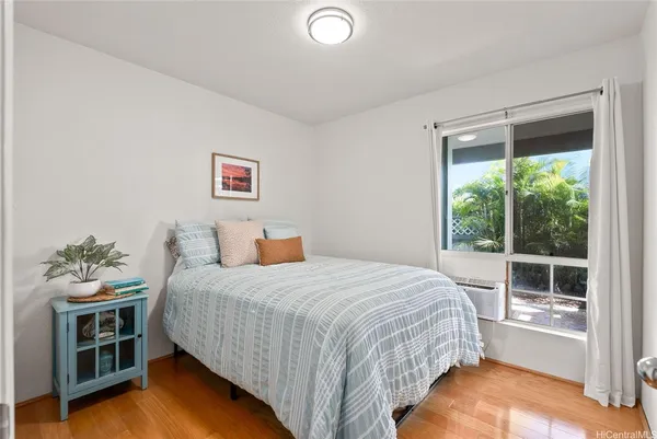 a bedroom with a bed and wooden floor