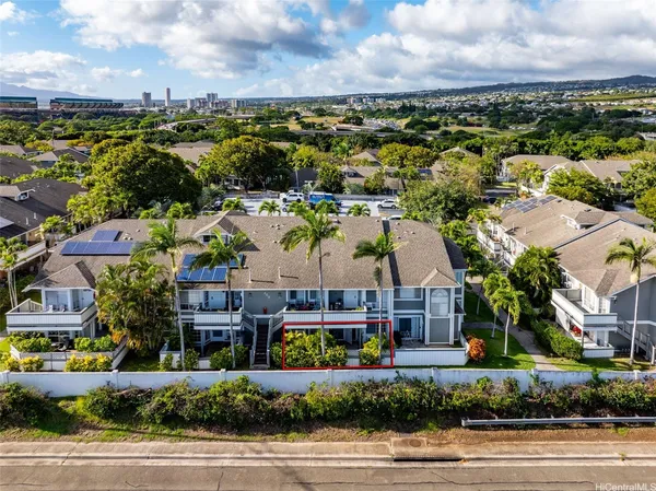 an aerial view of residential houses with outdoor space and ocean view