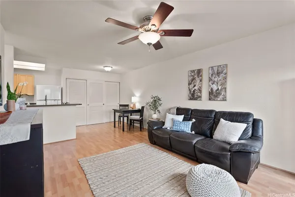 a living room with furniture and kitchen view