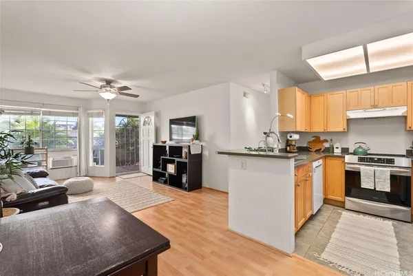 a large white kitchen with granite countertop a large window