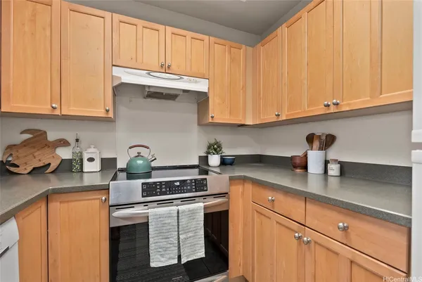 a kitchen with stainless steel appliances granite countertop a sink a stove and cabinets