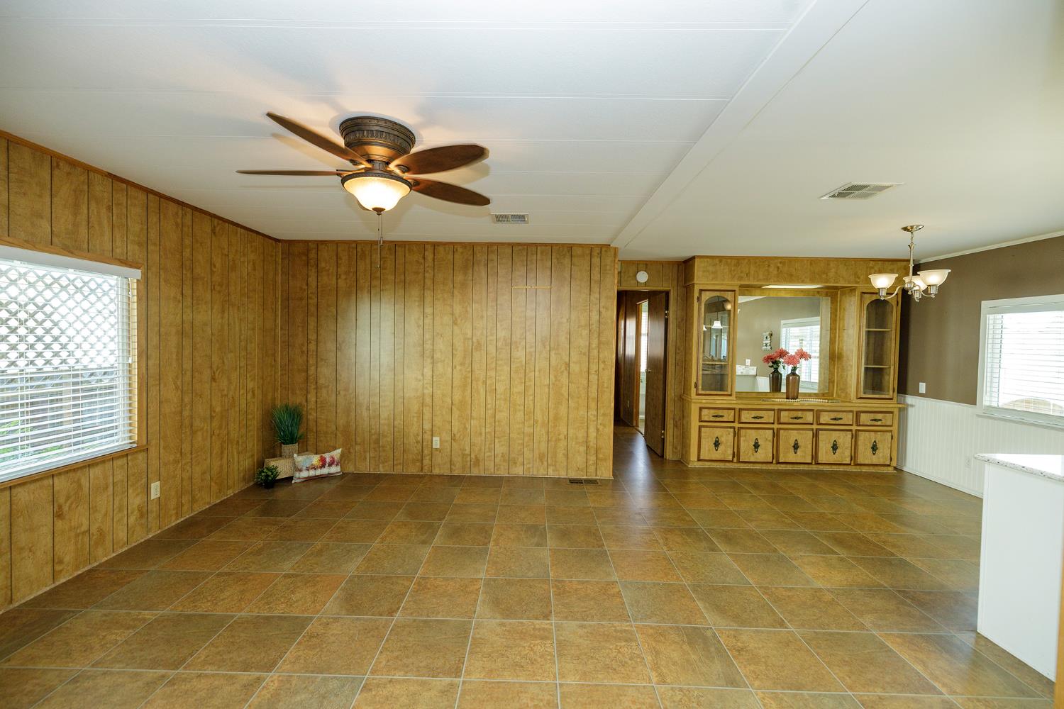 3418 North Waring Road, Unit 24 Denair, CA 95316 - Photo 12 of 48 a view of a livingroom with a patio and a yard