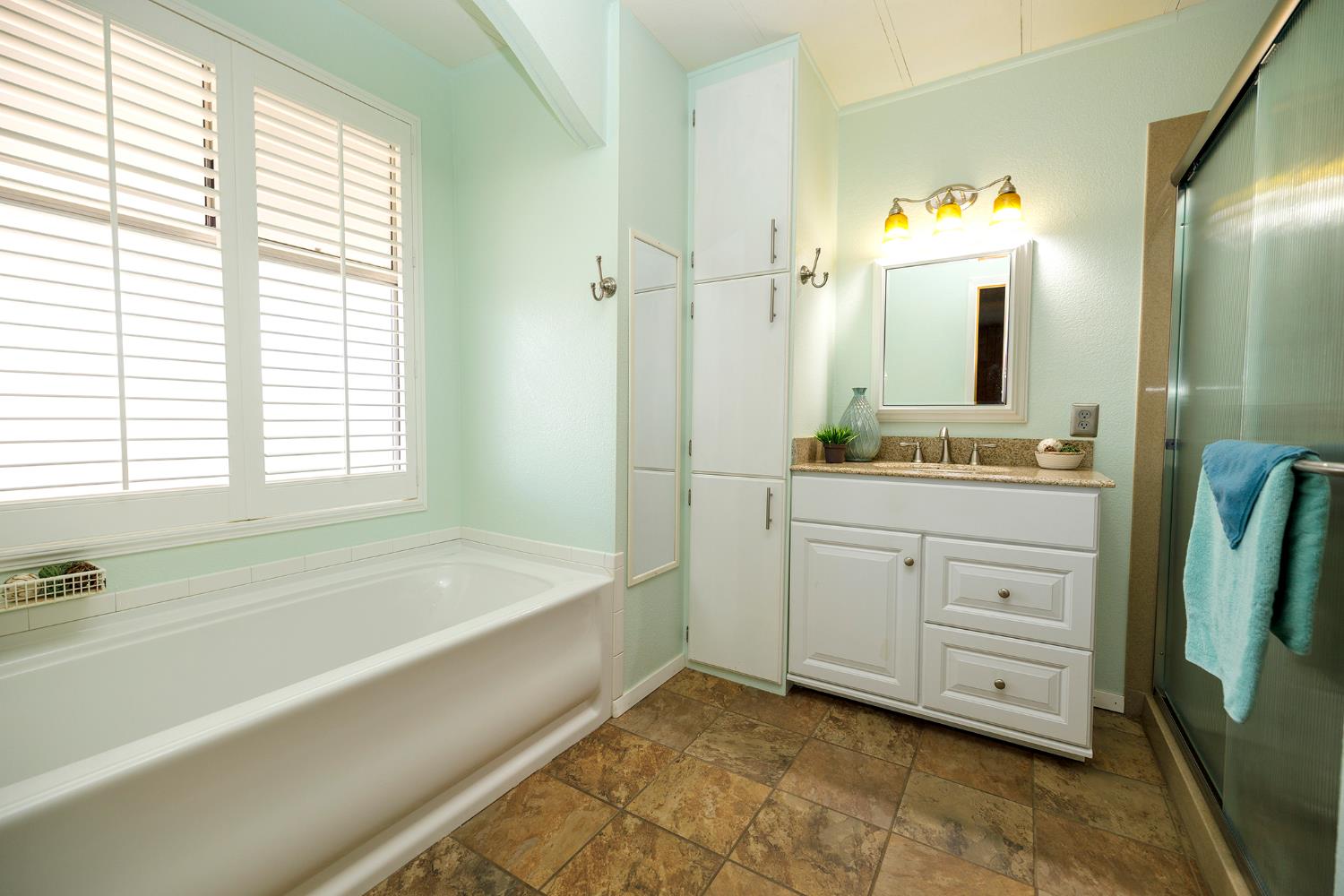 3418 North Waring Road, Unit 24 Denair, CA 95316 - Photo 21 of 48 a spacious bathroom with a tub sink and mirror