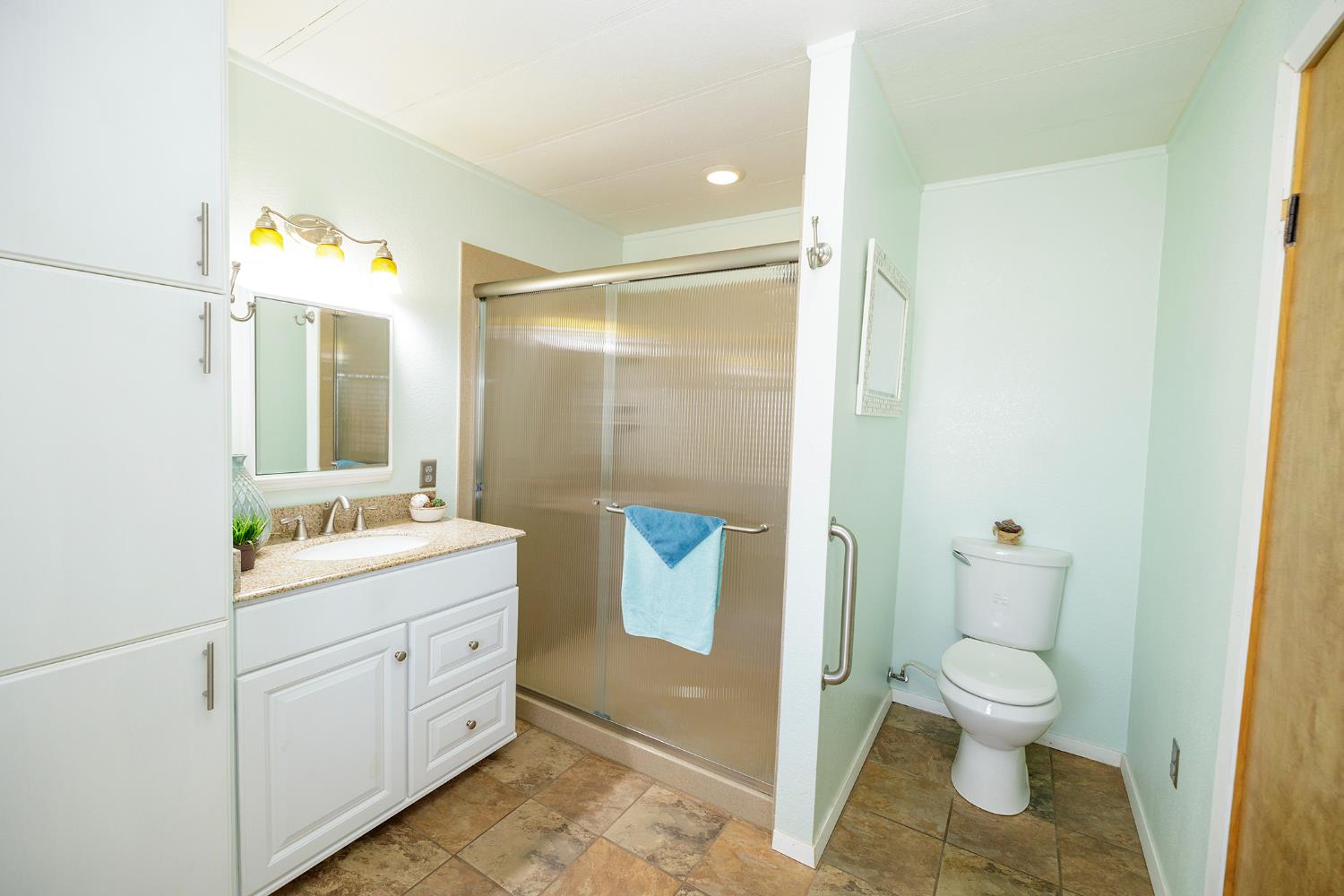 3418 North Waring Road, Unit 24 Denair, CA 95316 - Photo 23 of 48 a bathroom with a granite countertop sink toilet and shower