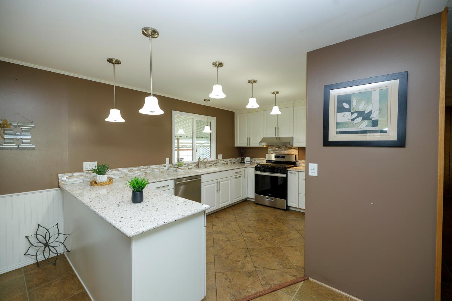 3418 North Waring Road, Unit 24 Denair, CA 95316 - Photo 3 of 48 a kitchen with a sink cabinets and wooden floor