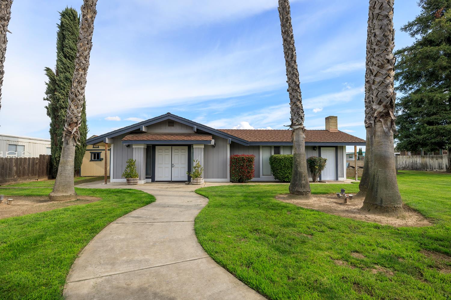 3418 North Waring Road, Unit 24 Denair, CA 95316 - Photo 41 of 48 a front view of a house with a yard and garage