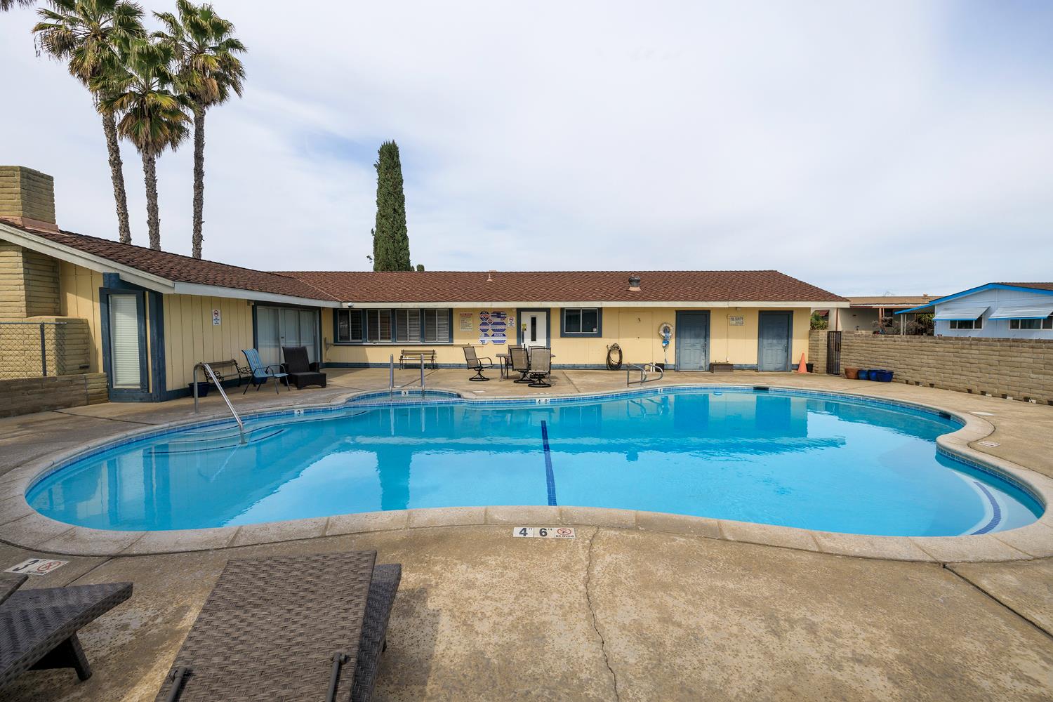 3418 North Waring Road, Unit 24 Denair, CA 95316 - Photo 43 of 48 a view of a house with pool and chairs