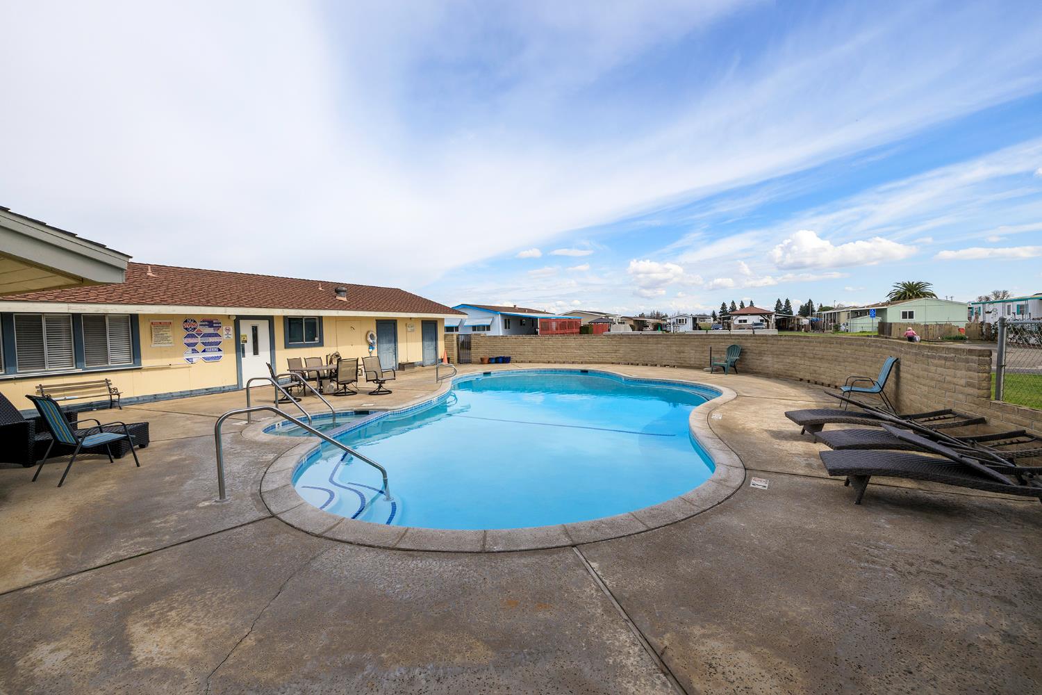 3418 North Waring Road, Unit 24 Denair, CA 95316 - Photo 44 of 48 a view of a swimming pool with lounge chair