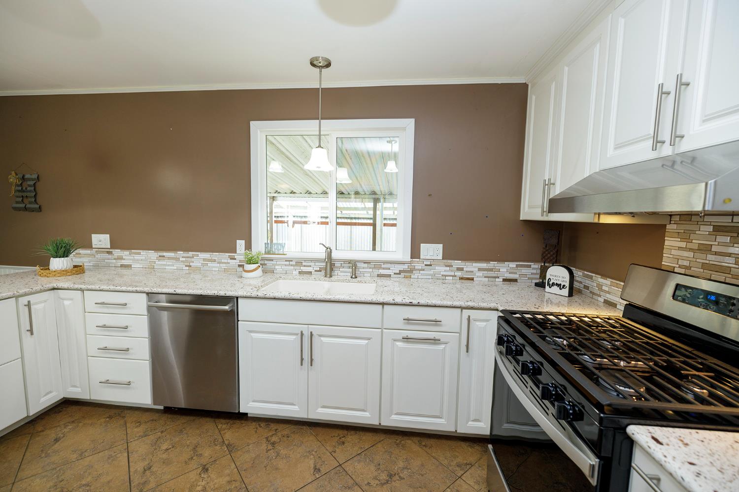 3418 North Waring Road, Unit 24 Denair, CA 95316 - Photo 6 of 48 a kitchen with a sink stove and cabinets