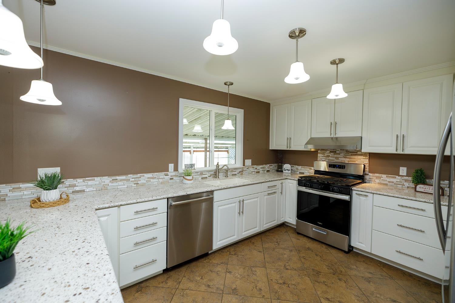 3418 North Waring Road, Unit 24 Denair, CA 95316 - Photo 8 of 48 a kitchen with a sink stove and cabinets