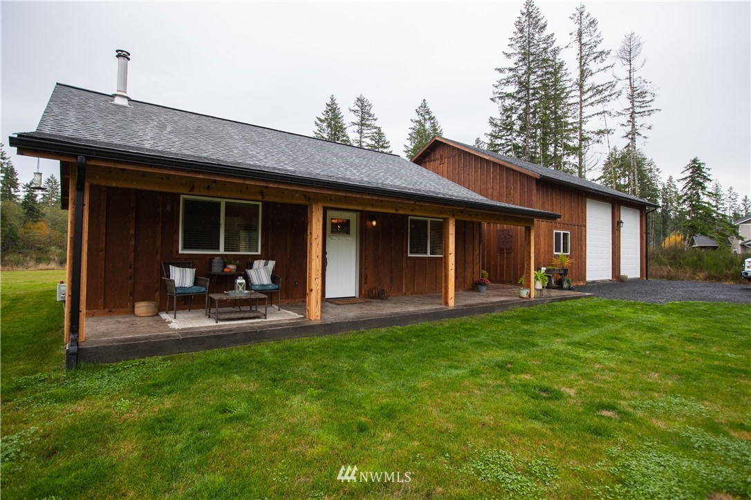 a front view of a house with patio and garden