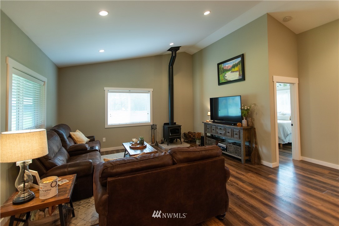 800 Logan Hill Road Chehalis, WA 98532 - Photo 12 of 36 a living room with furniture a large window and a flat screen tv