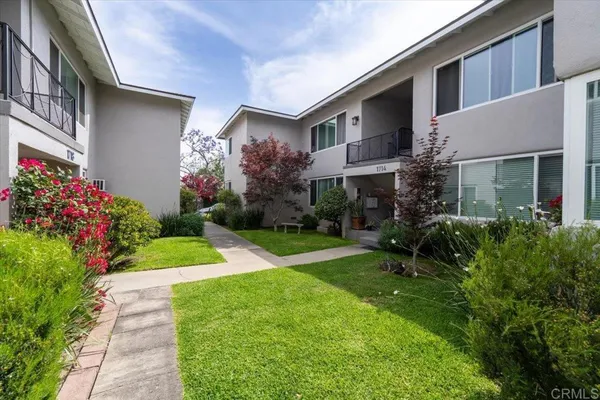 a view of a house with a yard and plants