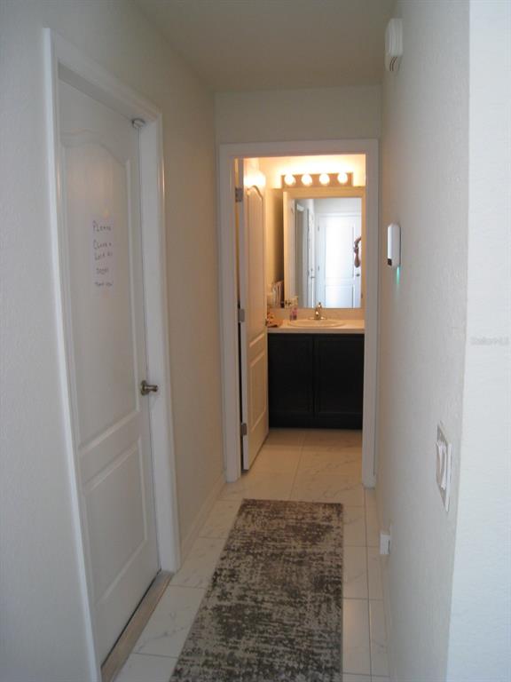 1300 Lucerne Loop Road Northeast Winter Haven, FL 33881 - Photo 20 of 40 Hallway to garage and guest bathroom.