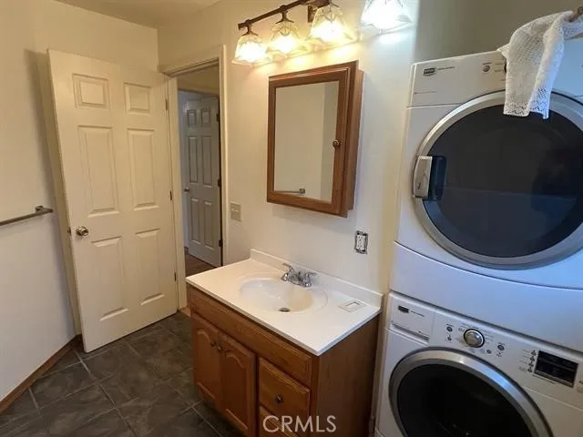 a utility room with sink dryer and washer
