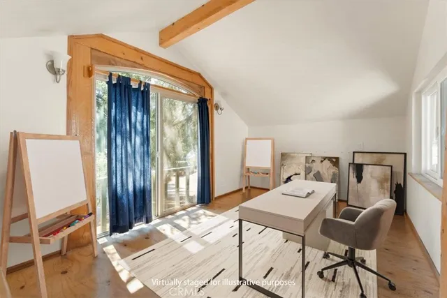 a bedroom with a bed and large windows