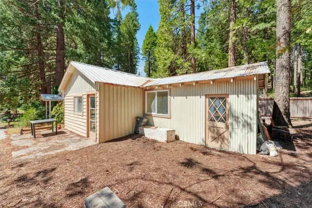 a view of a house with a backyard and sitting area