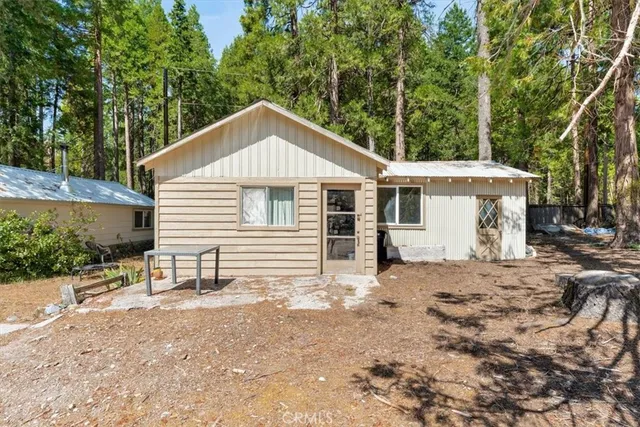 a view of a house with a yard and sitting area