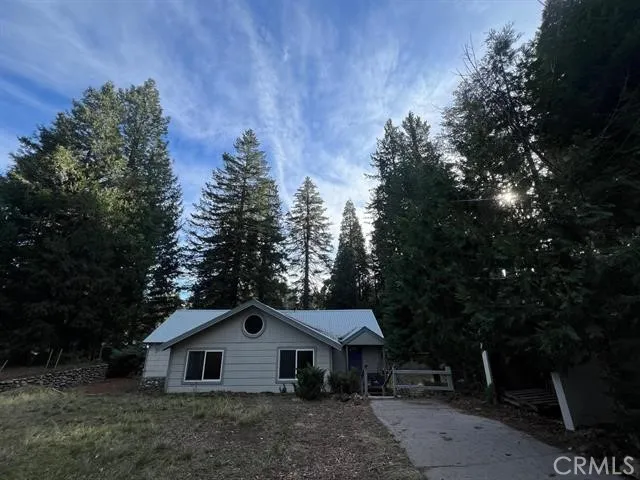 a front view of a house with trees