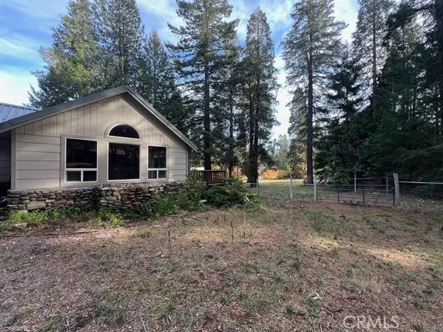 a view of a house with yard and a tree