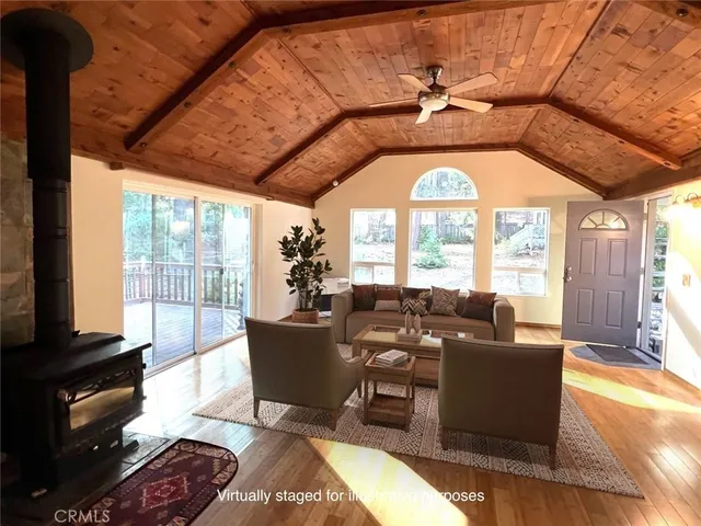 a living room with furniture and a floor to ceiling window