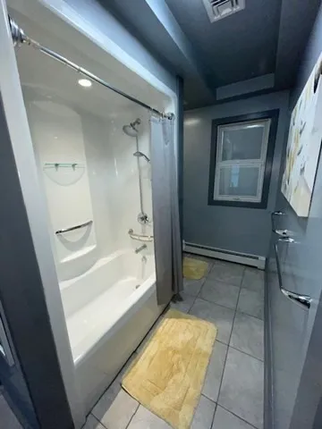 a white toilet sitting next to a small window