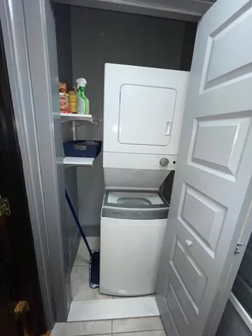 a black leather couch in living room with fireplace