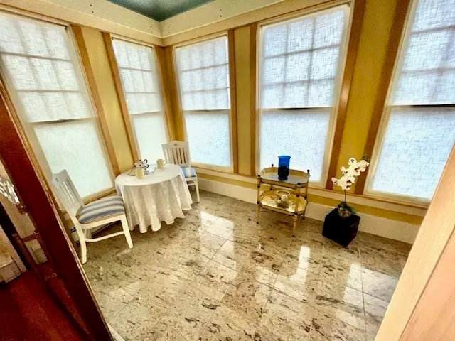 a large bedroom with a bed and wooden floor