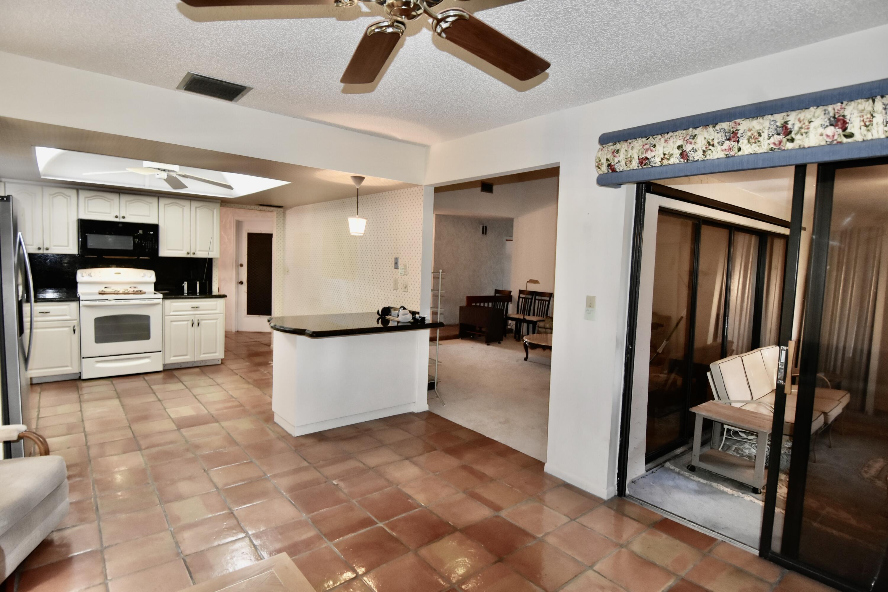 18101 Grove Avenue Boca Raton, FL 33498 - Photo 4 of 12 a view of kitchen with furniture and flat screen tv