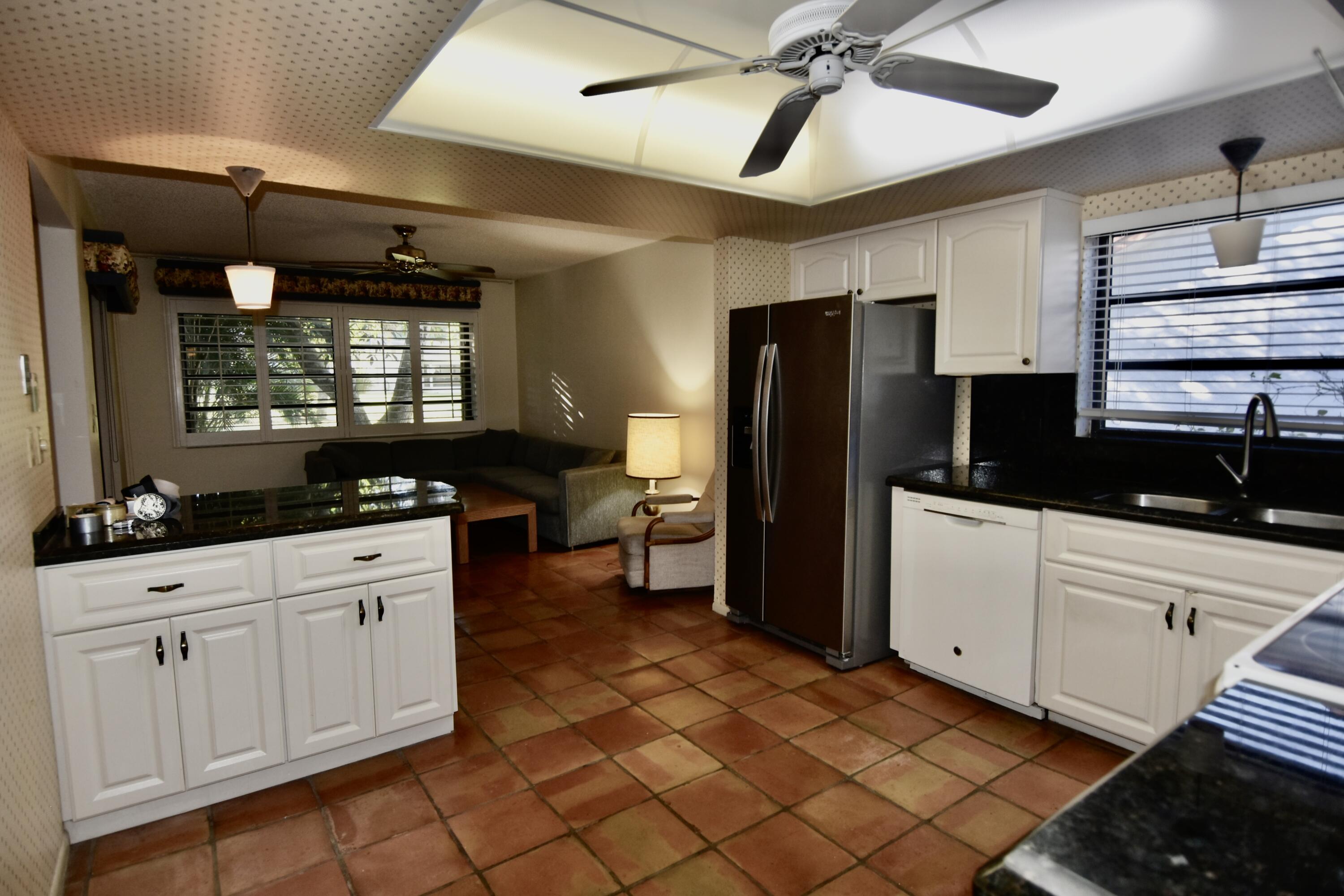 18101 Grove Avenue Boca Raton, FL 33498 - Photo 6 of 12 a kitchen with a refrigerator a sink and cabinets