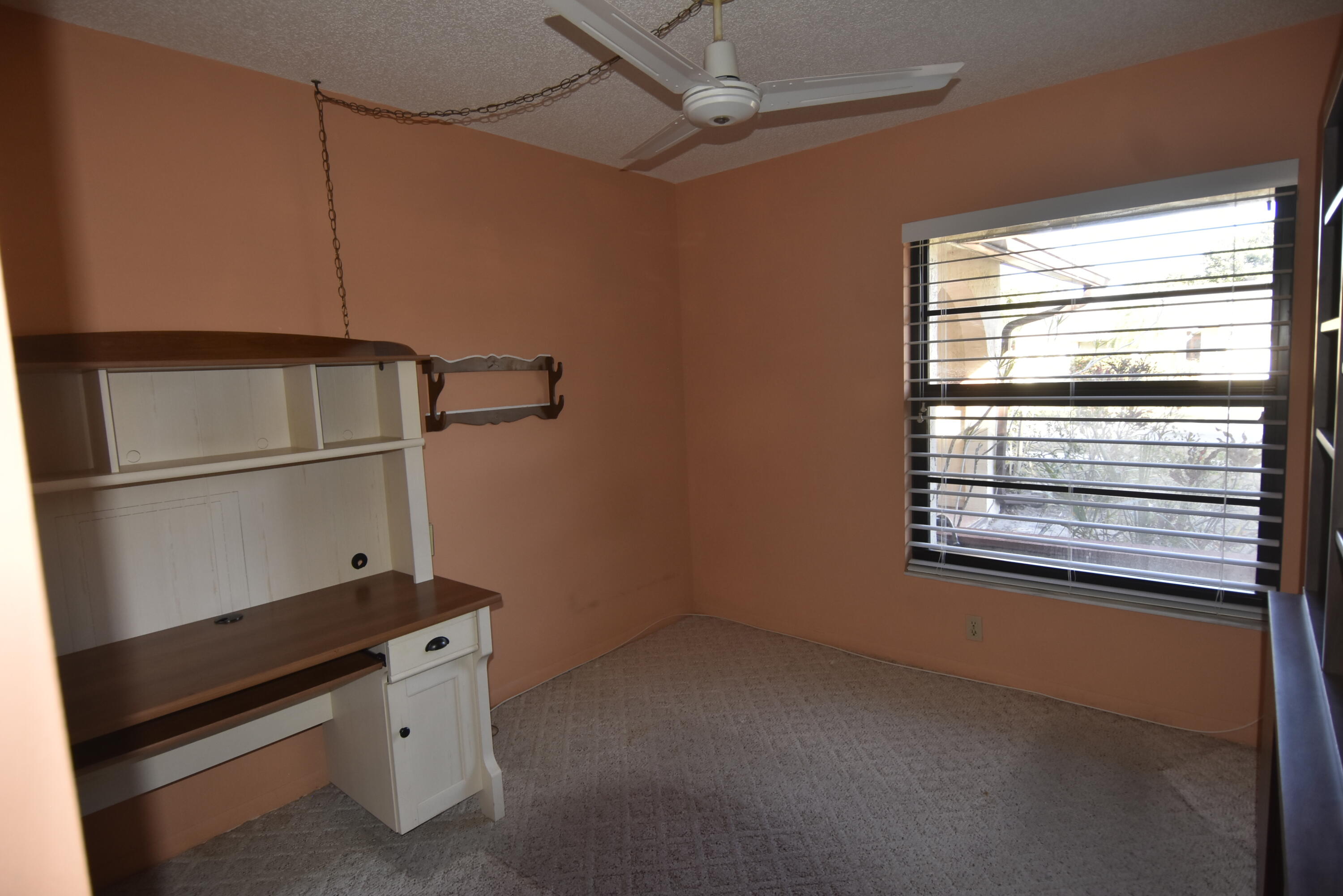 18101 Grove Avenue Boca Raton, FL 33498 - Photo 9 of 12 a room with rack on the wall and a window