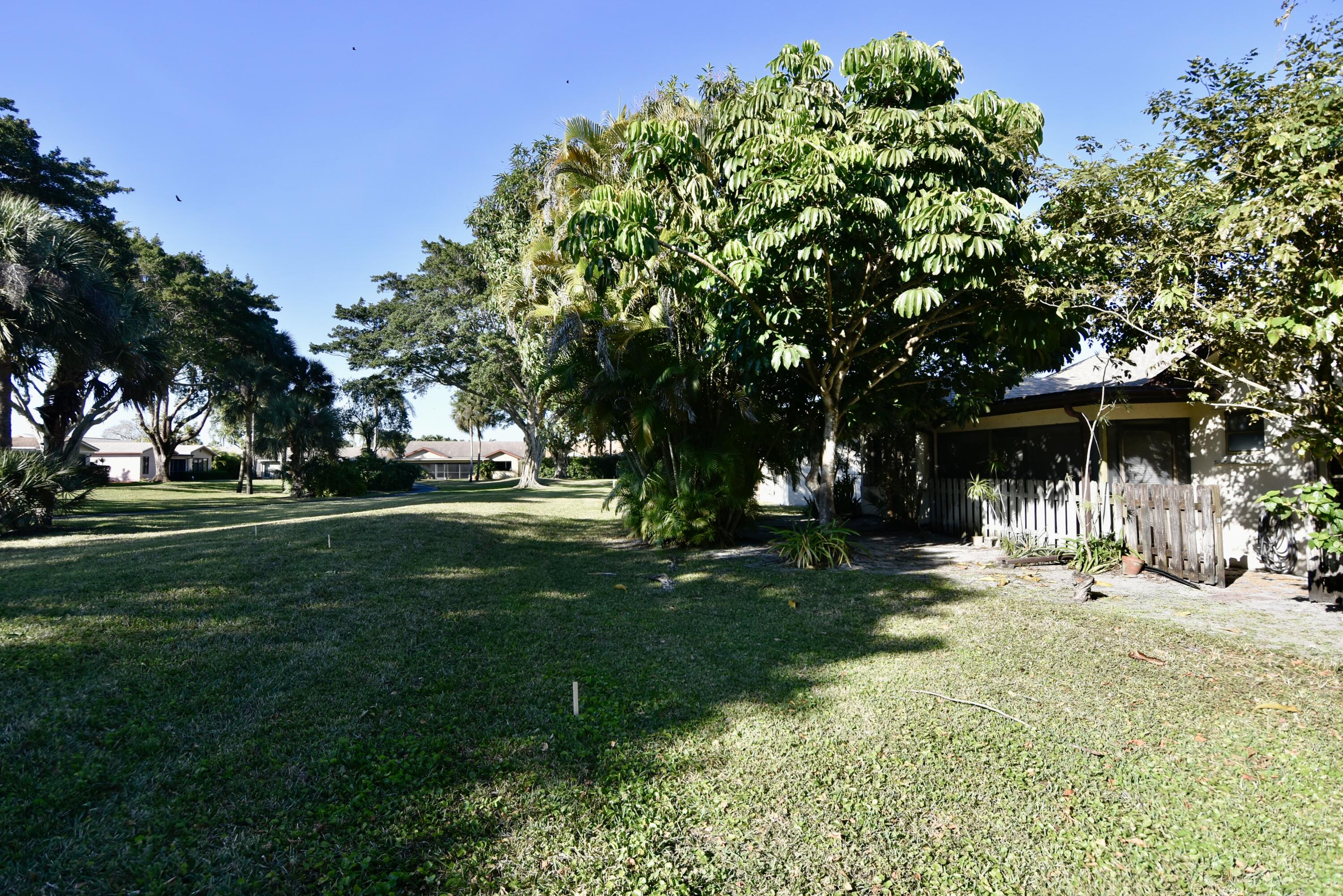 18101 Grove Avenue Boca Raton, FL 33498 - Photo 10 of 12 a front view of a house with a yard