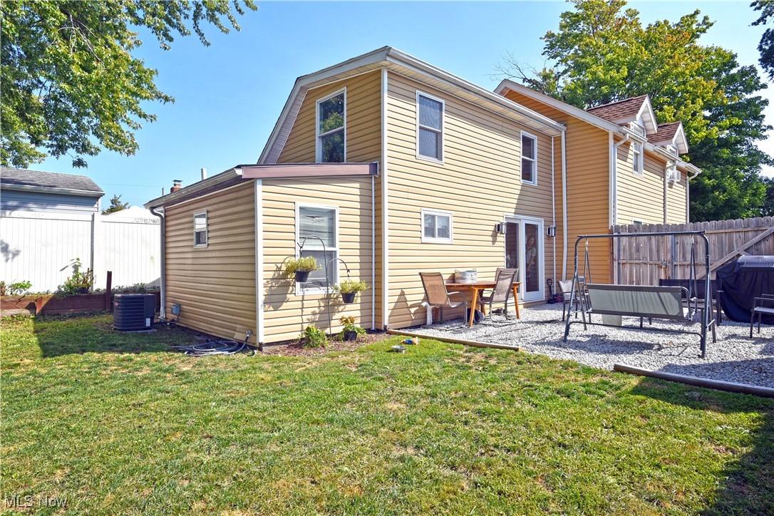 464 Stanley Road Akron, OH 44312 - Photo 23 of 25 Back of property featuring central air condition unit, a lawn, and a patio