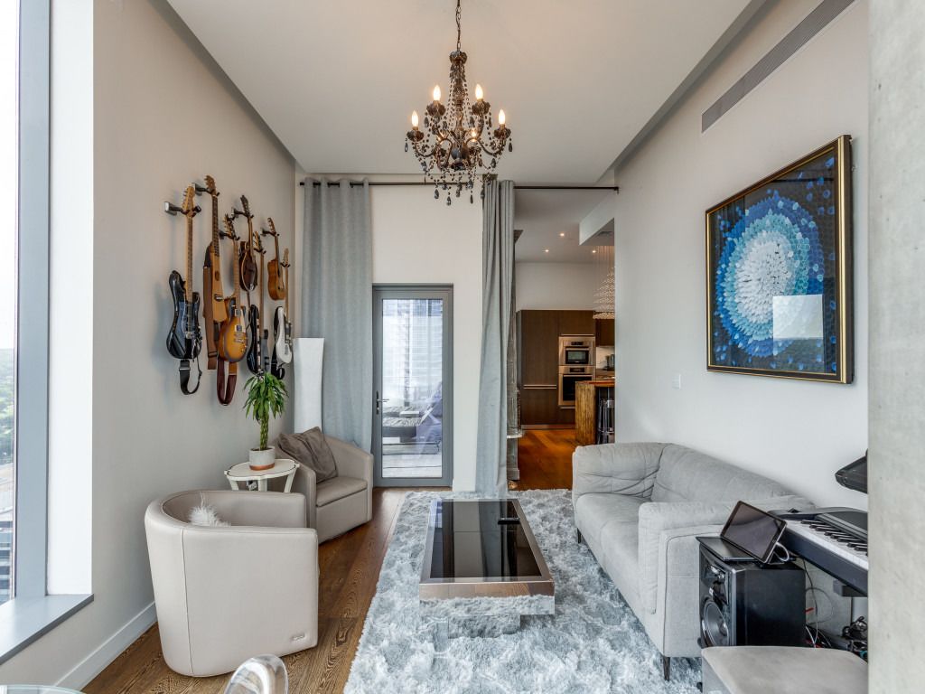 210 Lavaca Street, Unit 1801 Austin, TX 78701 - Photo 7 of 25 a living room with furniture and a chandelier