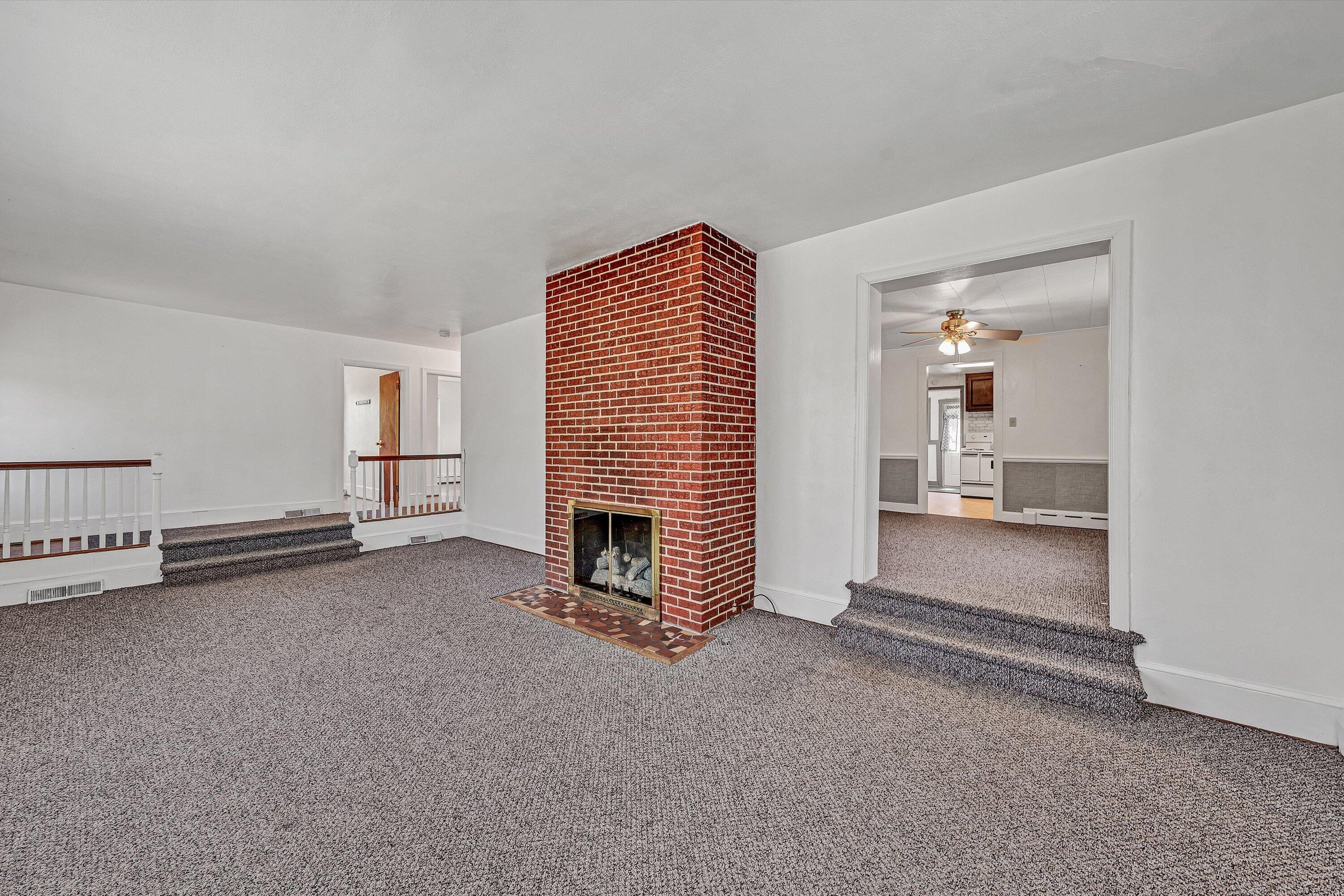 2356 West Riverside Drive Salem, VA 24153 - Photo 4 of 18 a view of a livingroom with furniture and a fireplace