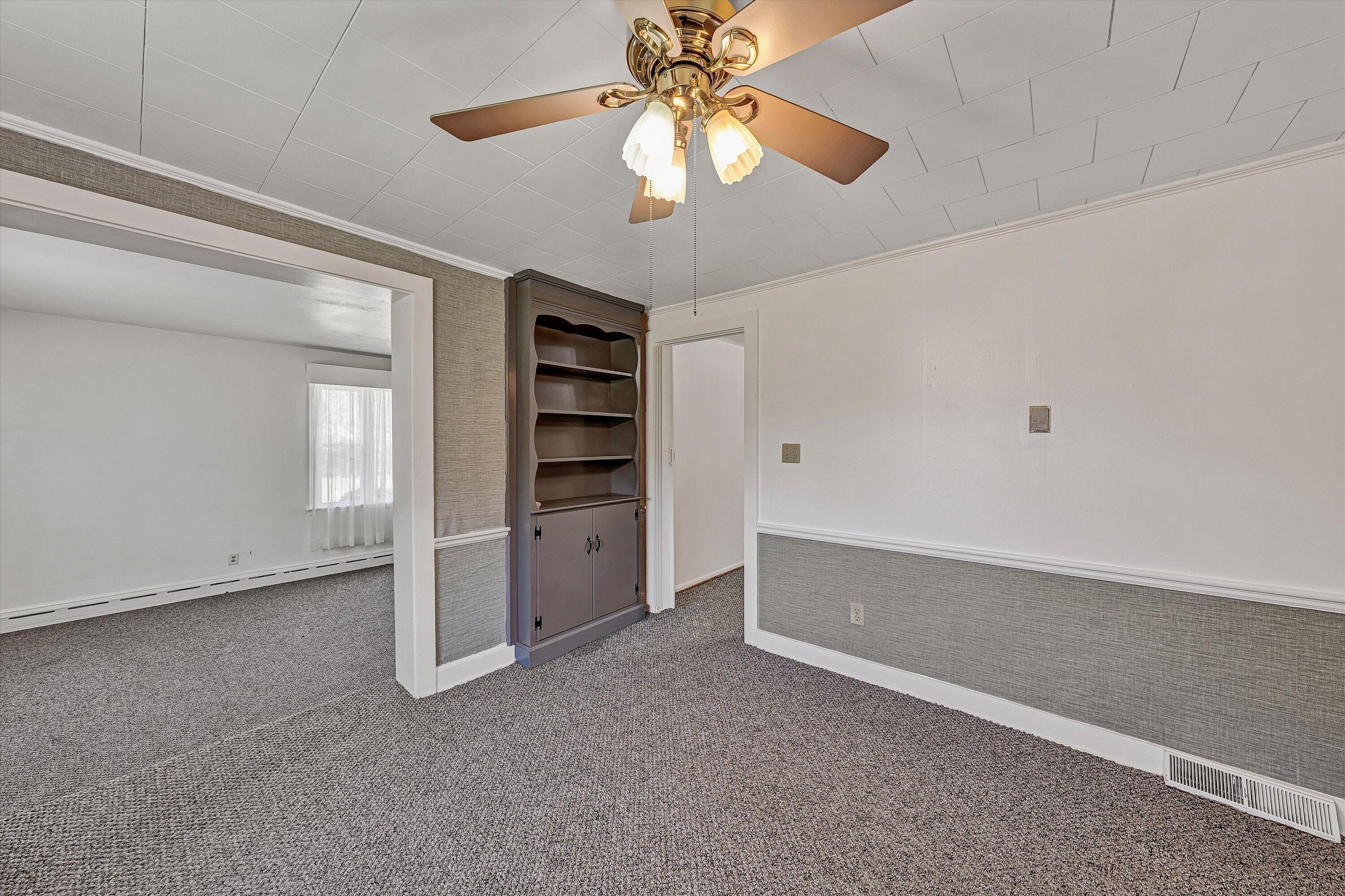 2356 West Riverside Drive Salem, VA 24153 - Photo 6 of 18 a view of an empty room with a ceiling fan and window