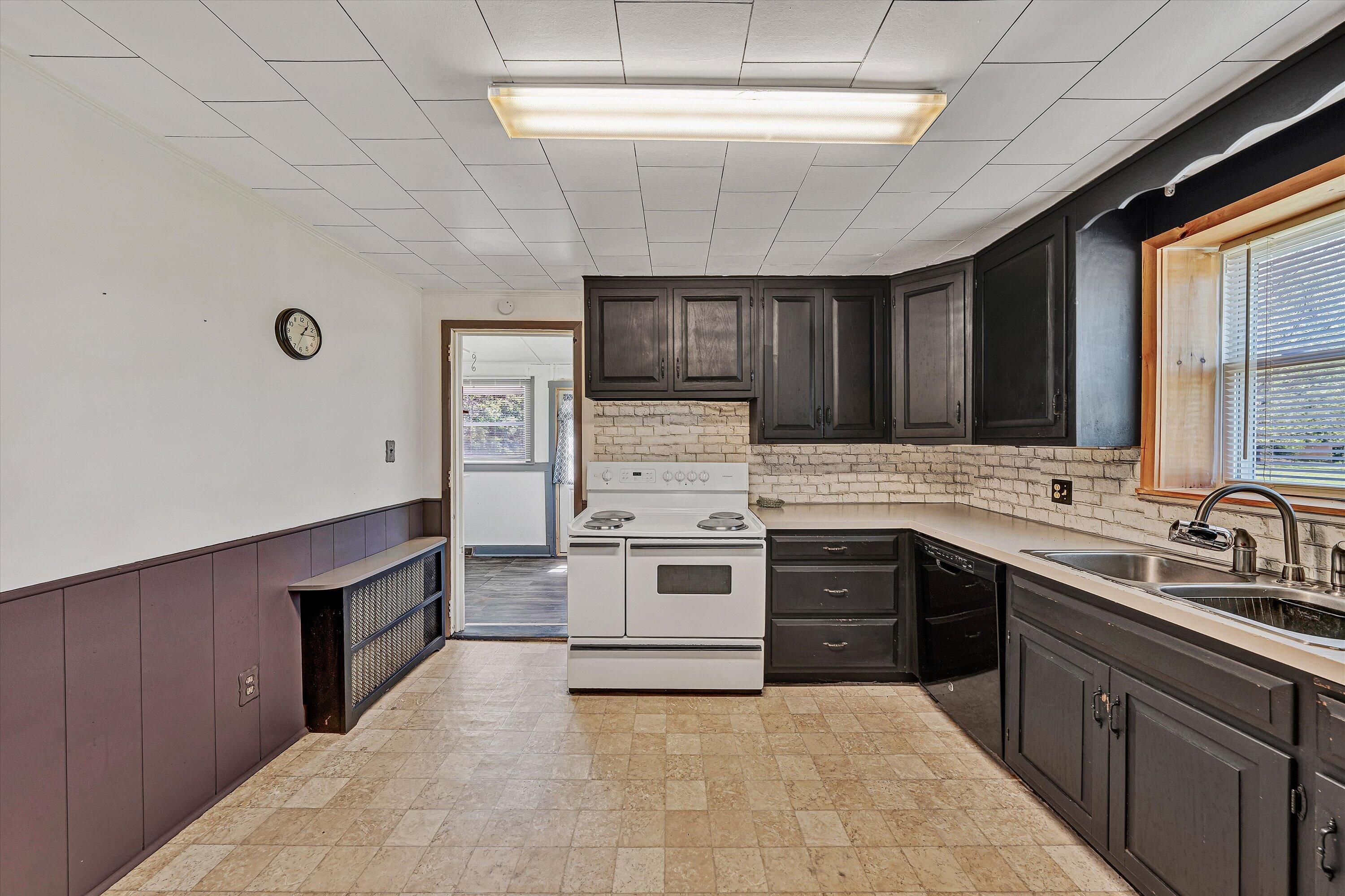 2356 West Riverside Drive Salem, VA 24153 - Photo 7 of 18 a kitchen with stainless steel appliances granite countertop a stove sink and cabinets