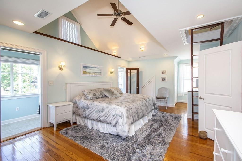 37 Damon Road Scituate, MA 02066 - Photo 21 of 39 a spacious bedroom with a large bed and a chandelier