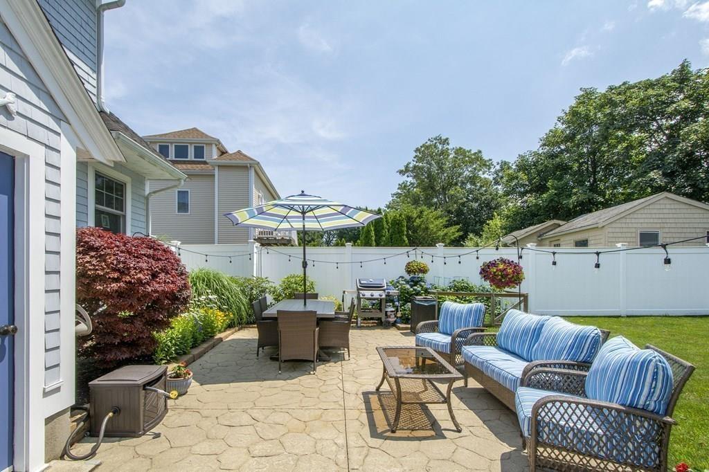 37 Damon Road Scituate, MA 02066 - Photo 27 of 39 a view of a chair and tables in the back yard of the house